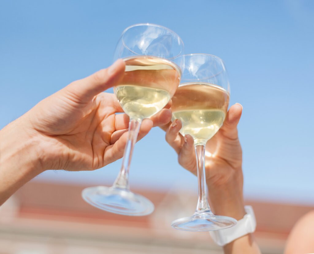 toasting glasses with white wine