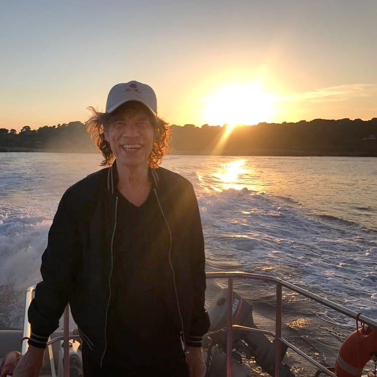 mick jagger in a speedboat in greece